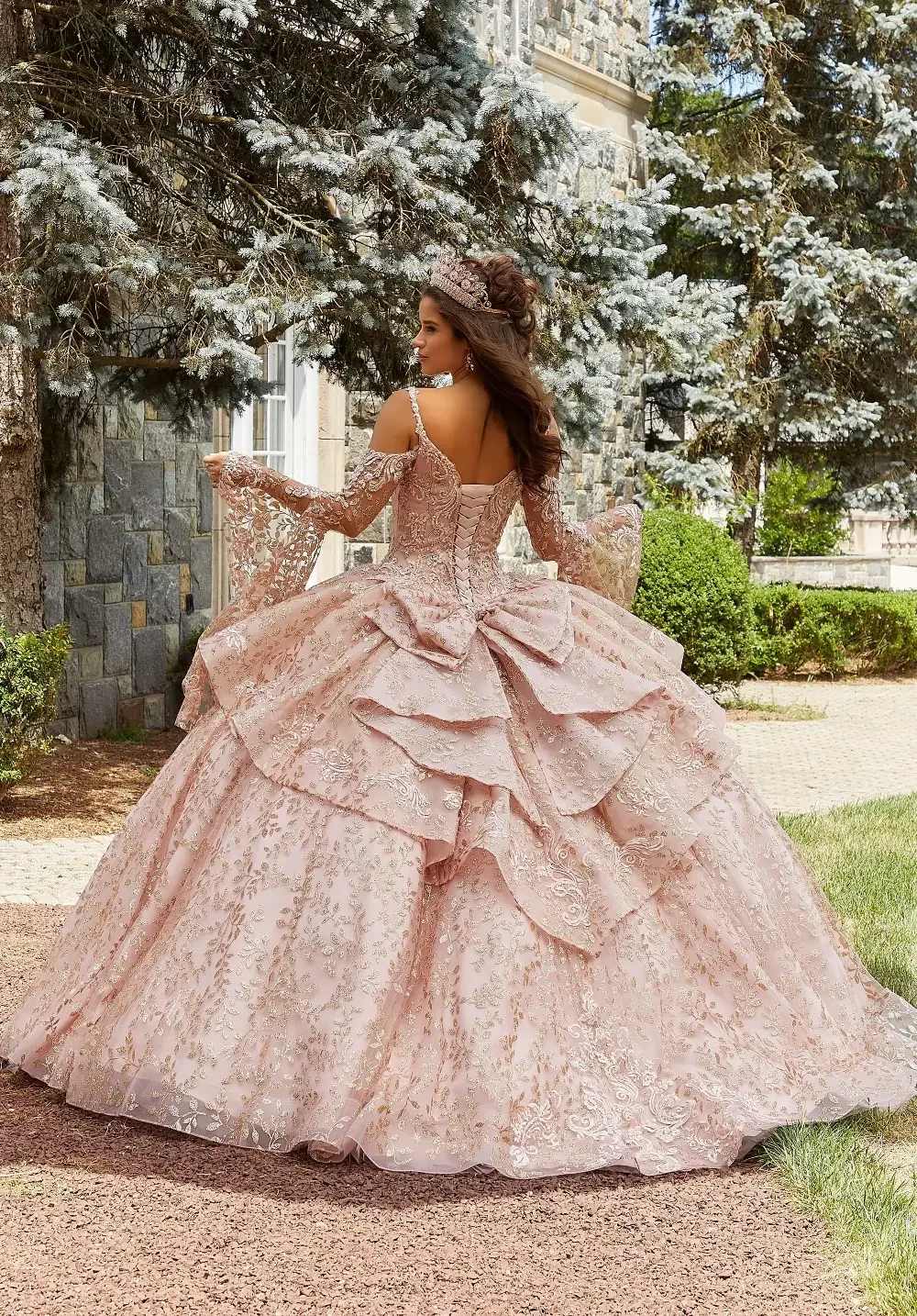 model is wearing a light pink quince gown with sleeves