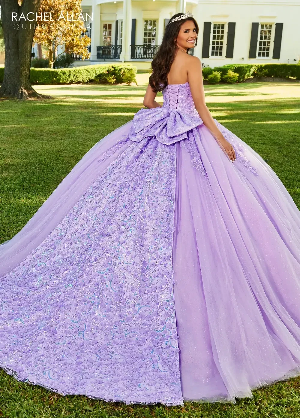 A girl in a lavender ball gown with intricate beading and a full skirt, smiling while standing outdoors.